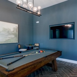 a clubroom with a pool table and a tv