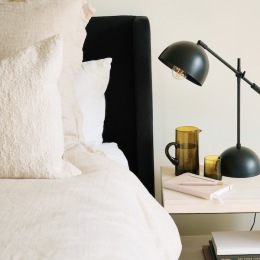 a bedroom with a bed and a nightstand