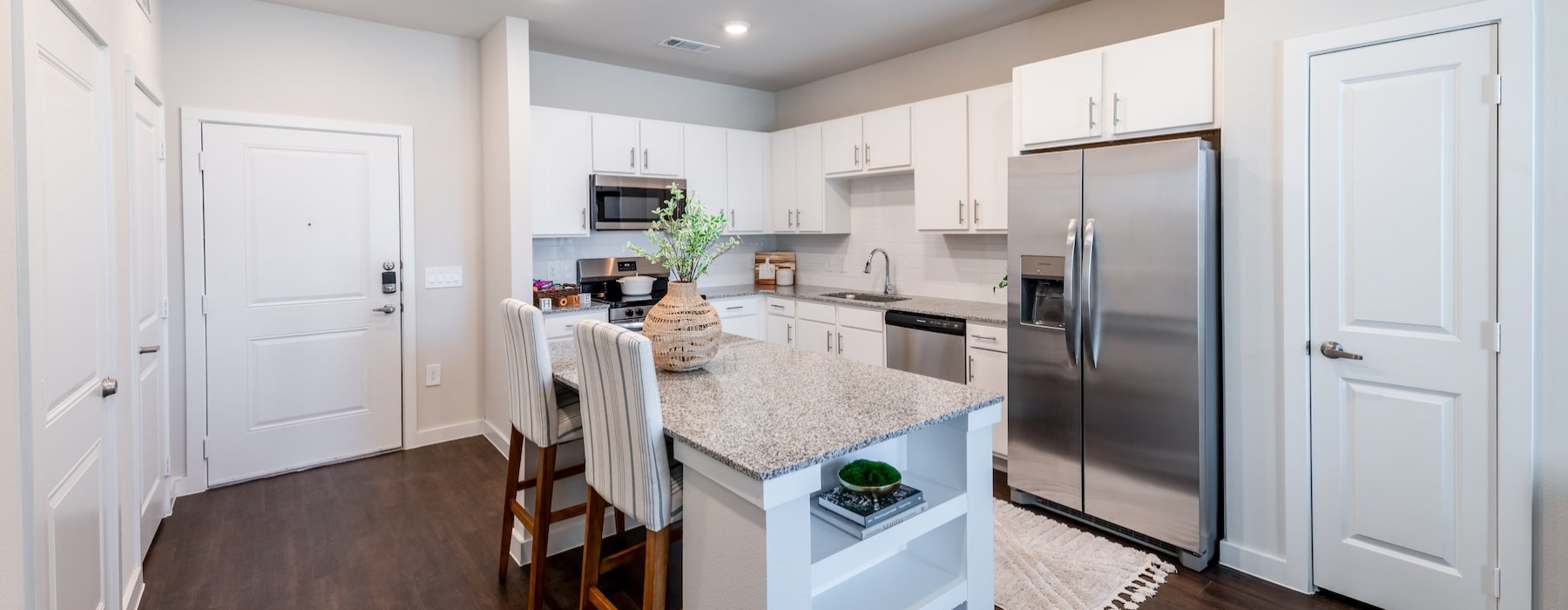 a kitchen with white cabinets