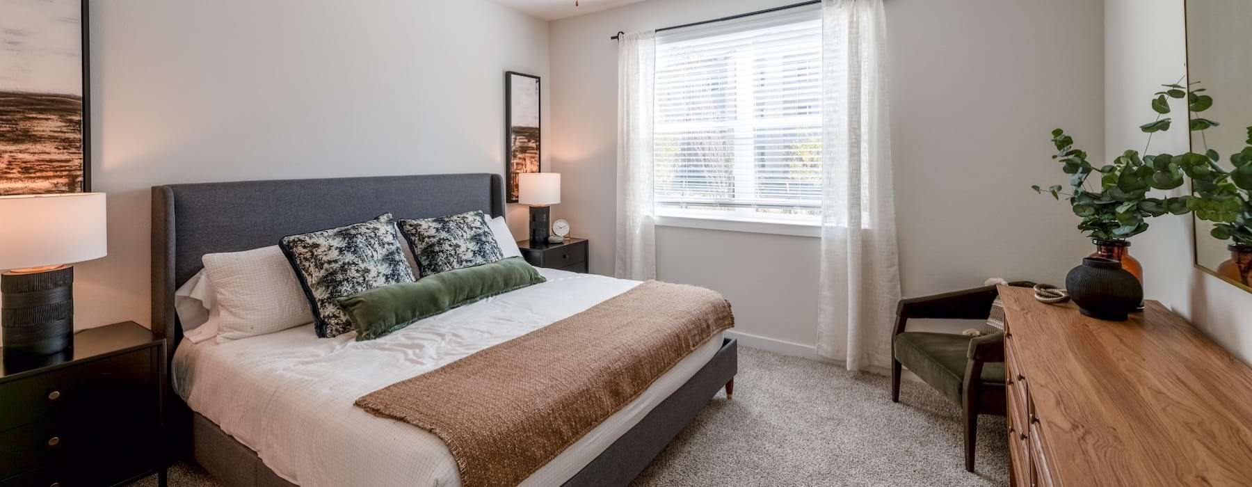 a bedroom with a bed and two nightstands