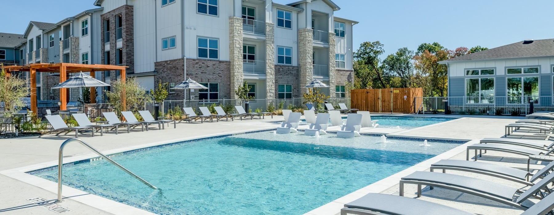 a pool with lounge chairs