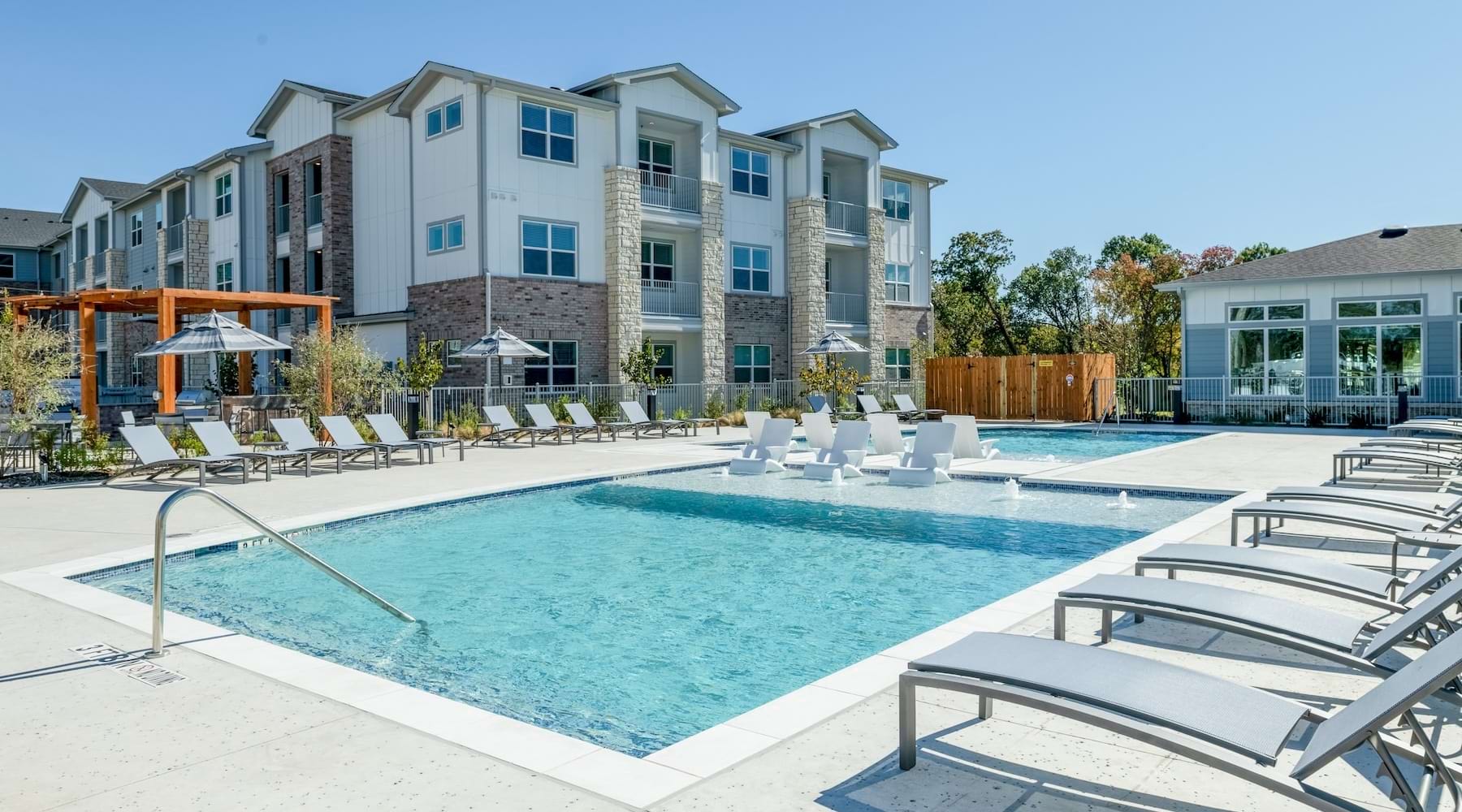 a pool with lounge chairs